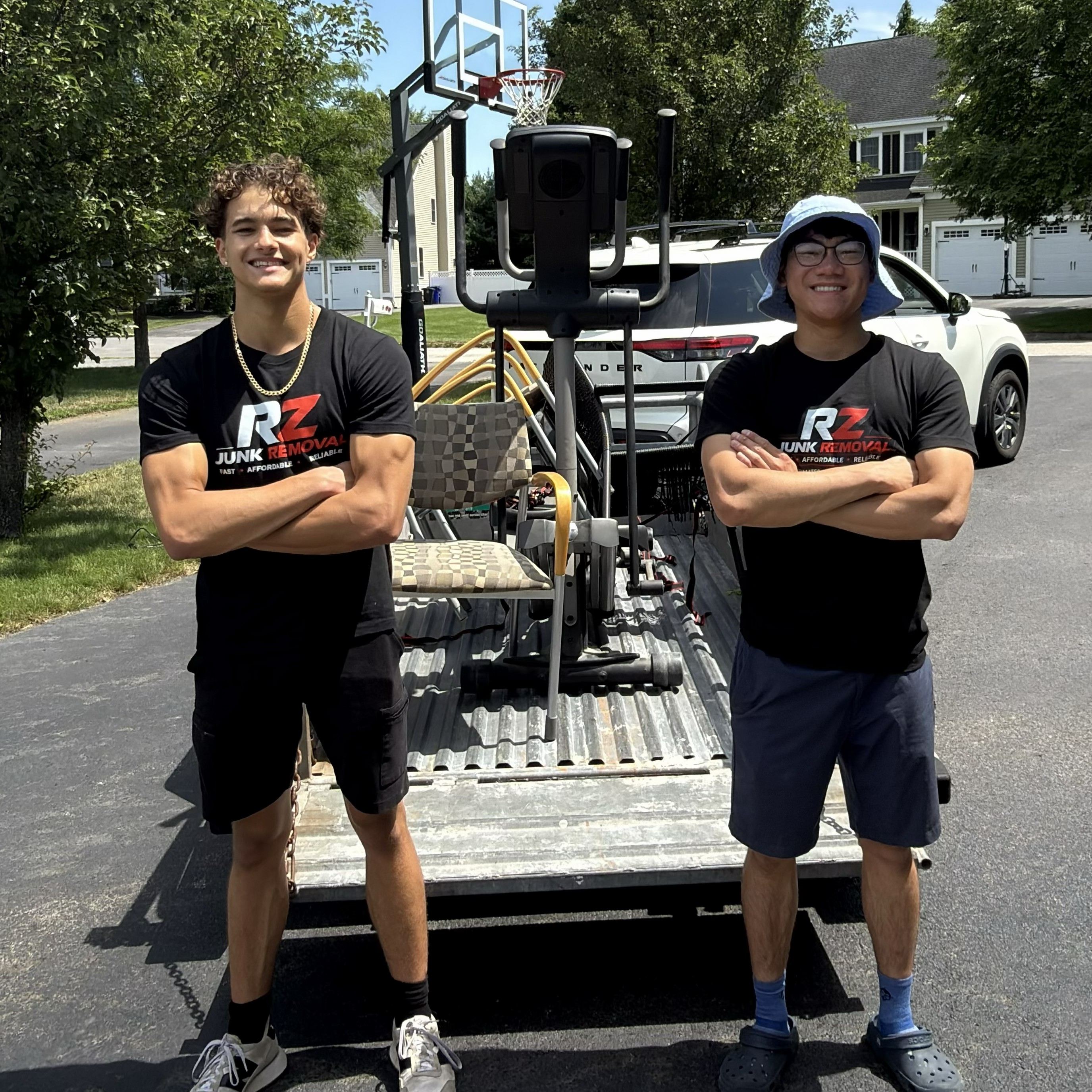 The two RZ Junk Removal owners standing in front of their truck